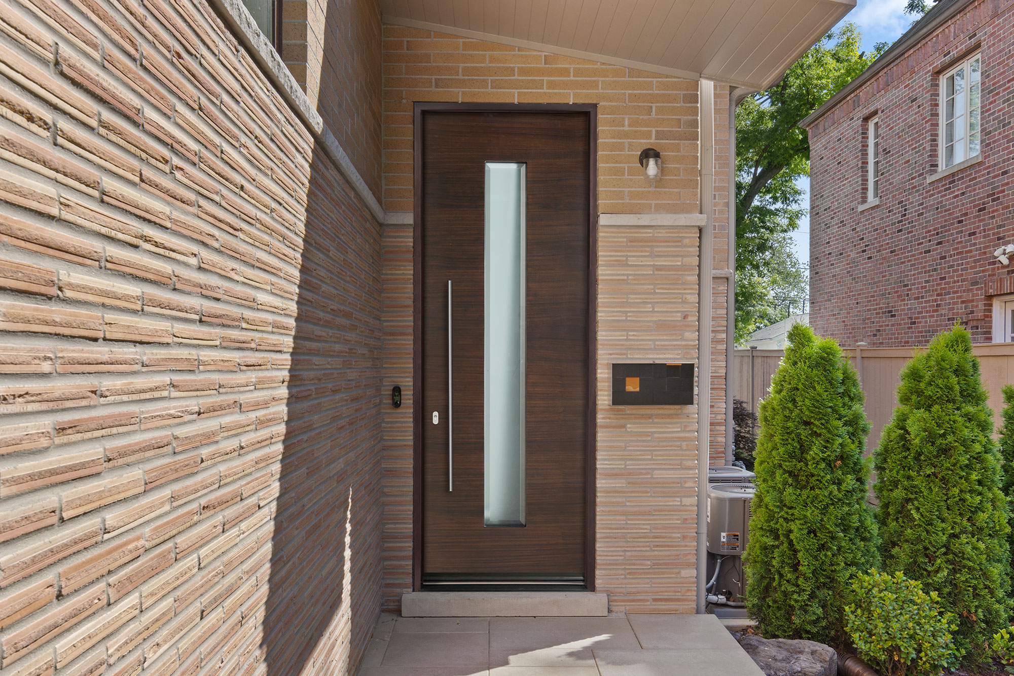 Classic white entry door with brass knob and welcome mat in front.