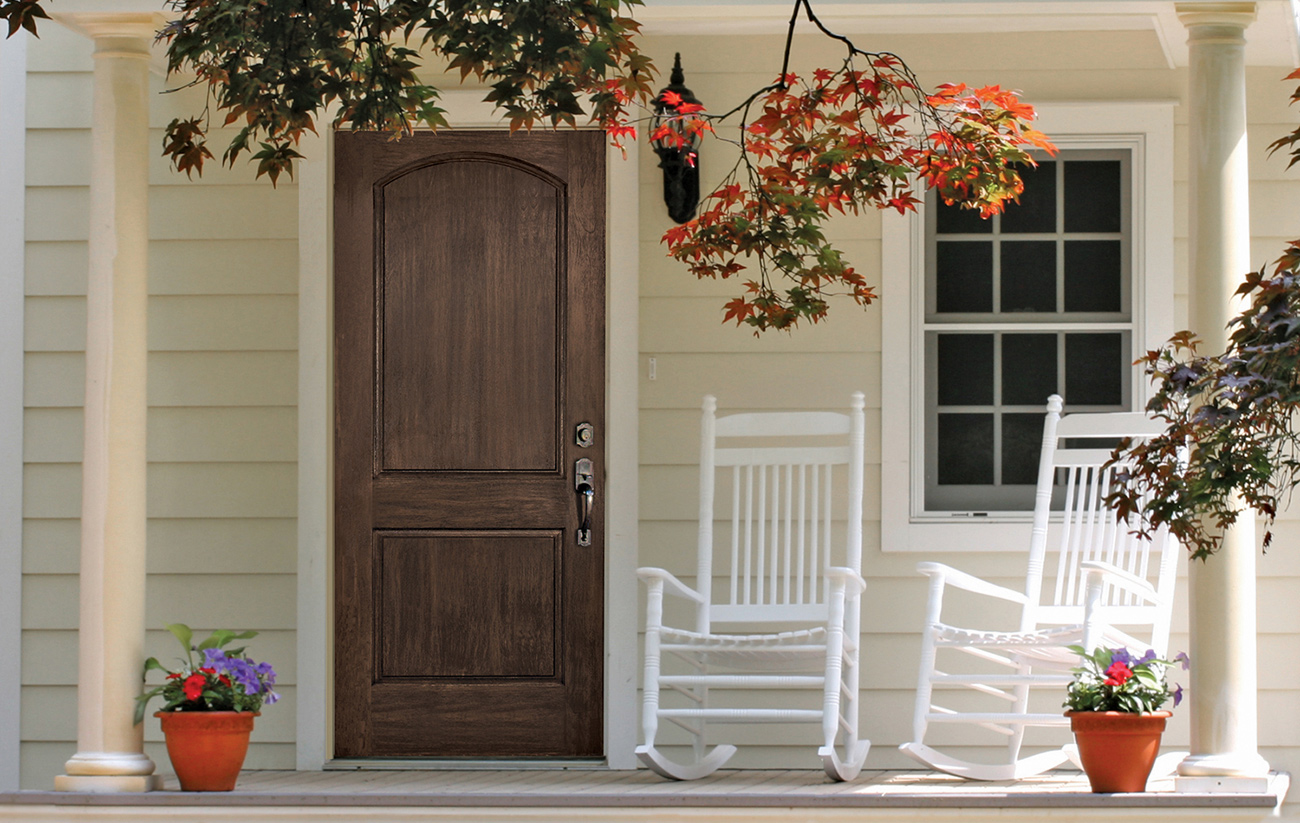 Rustic Front Door with Iron Accents and Natural Wood Grain Finish.
