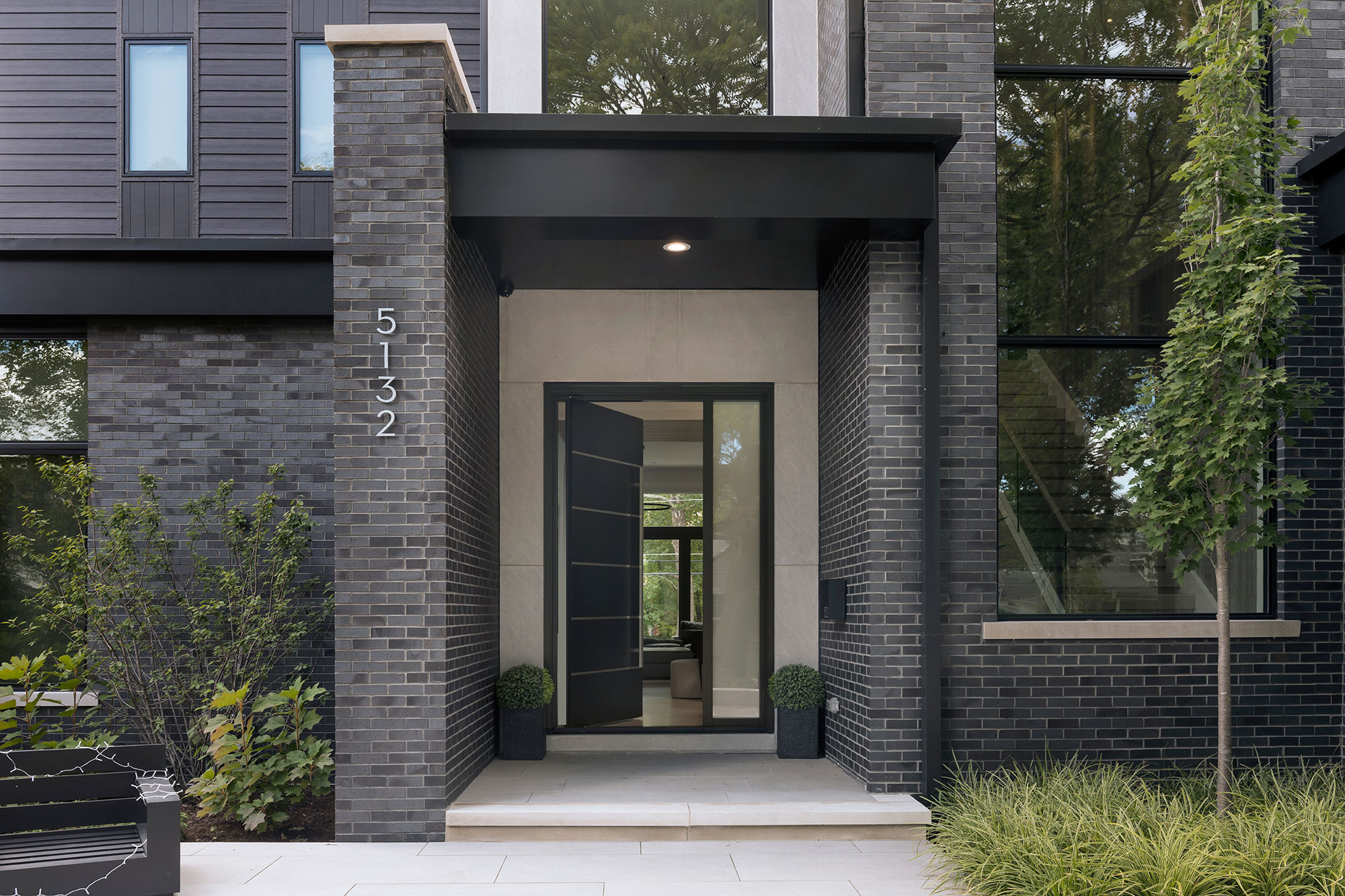 Elegant exterior door with sidelights and floral wreath decoration.
