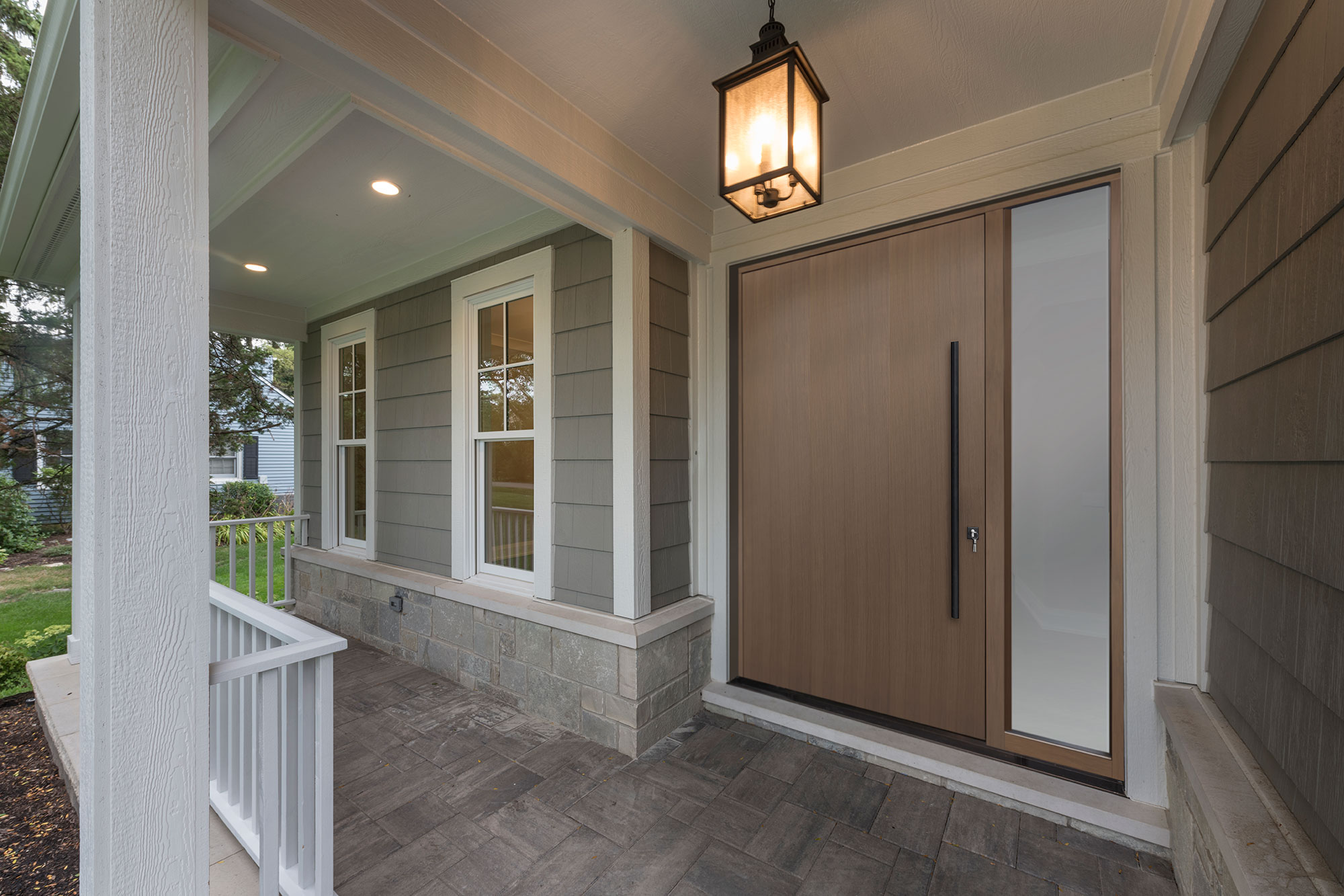 Wooden exterior door with decorative ironwork and arched transom window.