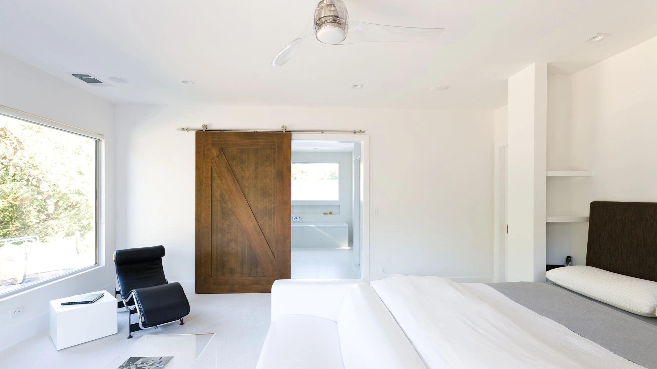 Decorative sliding wood barn door used as a stylish room divider.