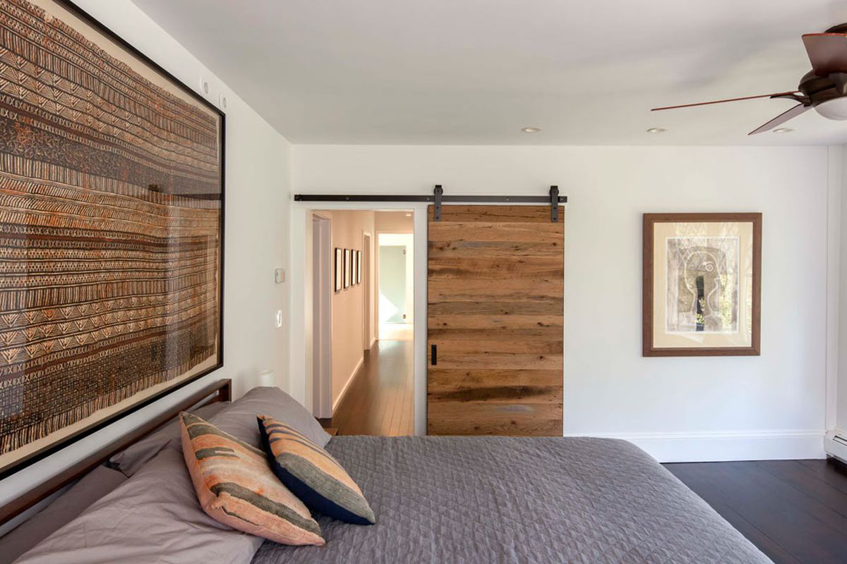 Modern wood barn door with smooth sliding track for space-saving interior design.