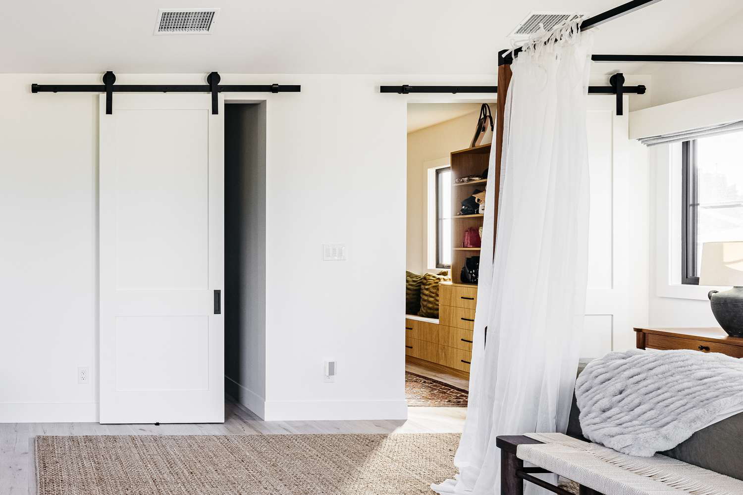 Custom wood barn door for interior home design with natural grain finish.